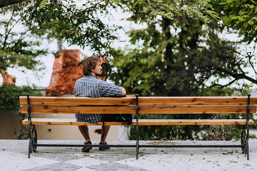 man sitting on a bench outside