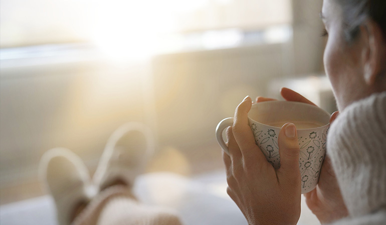 a woman having coffee